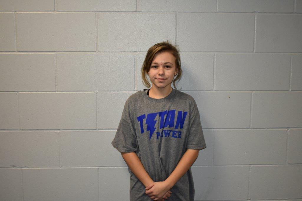 female student in a grey t-shirt with Titan Power in blue on it